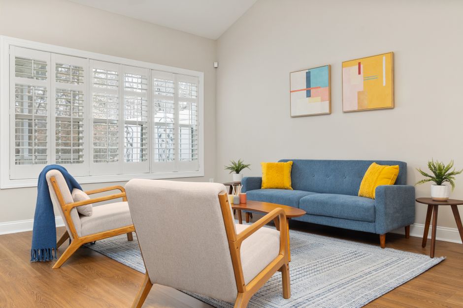 Beautifully lit living room with custom window shutters